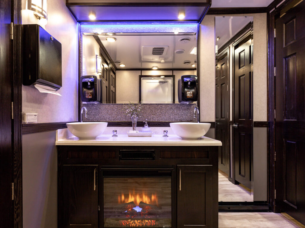 10-station luxury restroom trailer interior view of the fireplace and sinks