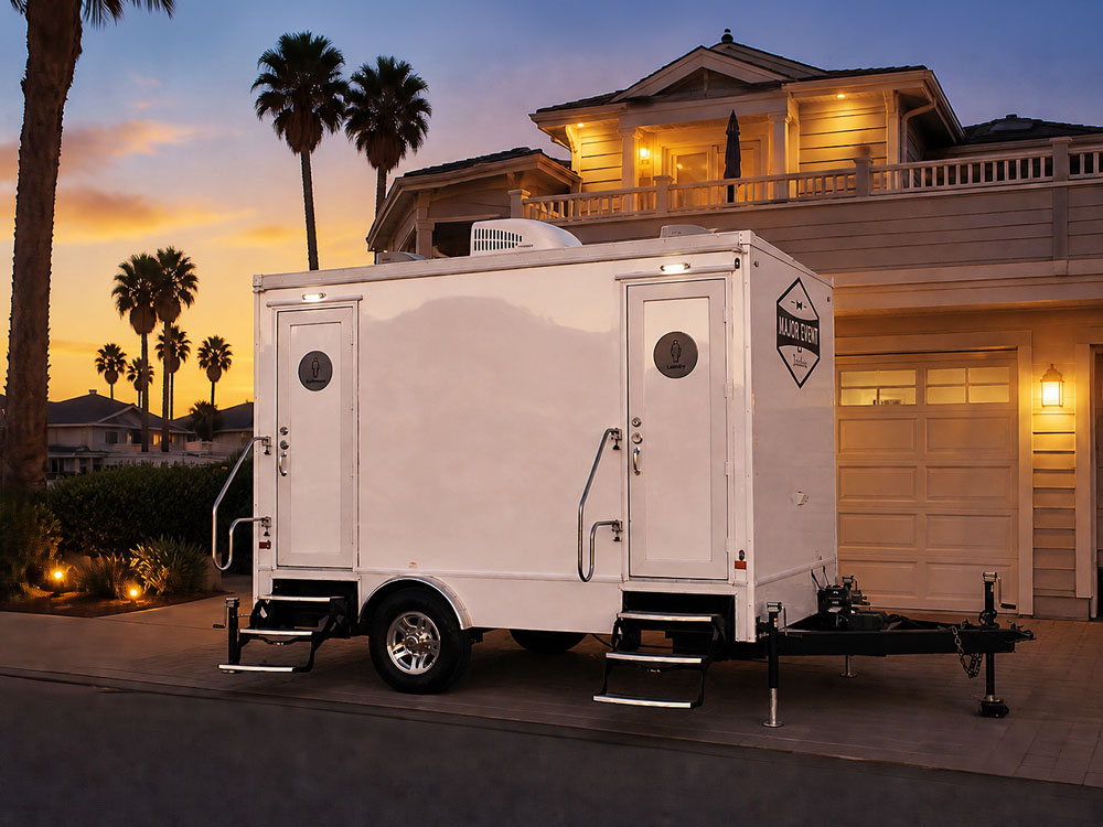 2-stall luxury restroom trailer in front of an Oxnard Shores home at sunset, offering upscale portable restroom rentals by Major Event Trailers